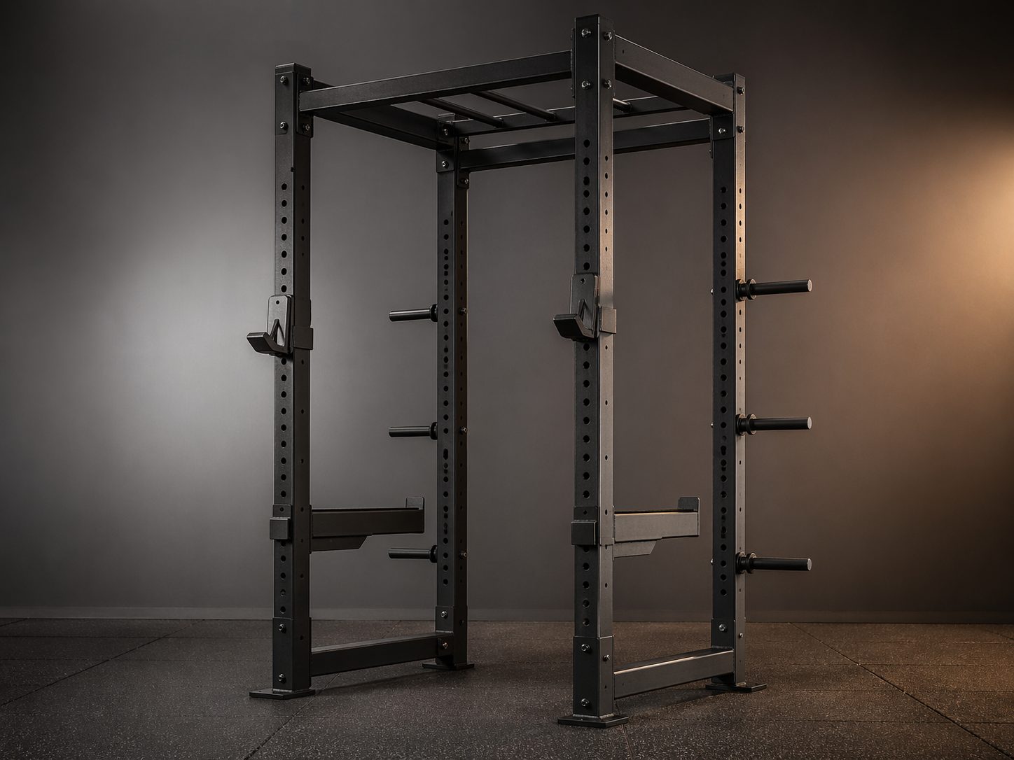 Commercial matte-black 4-post power rack with J-cups and safety arms, product-forward studio, ProHeavyFitness